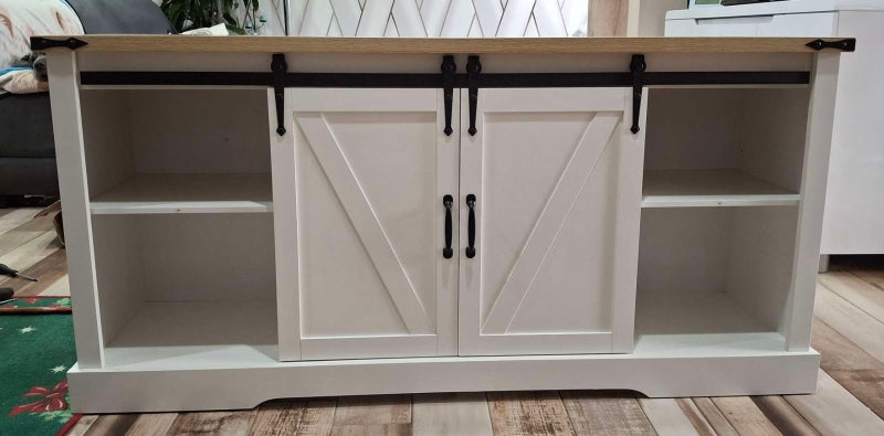 White cabinet with sliding doors on a wooden floor